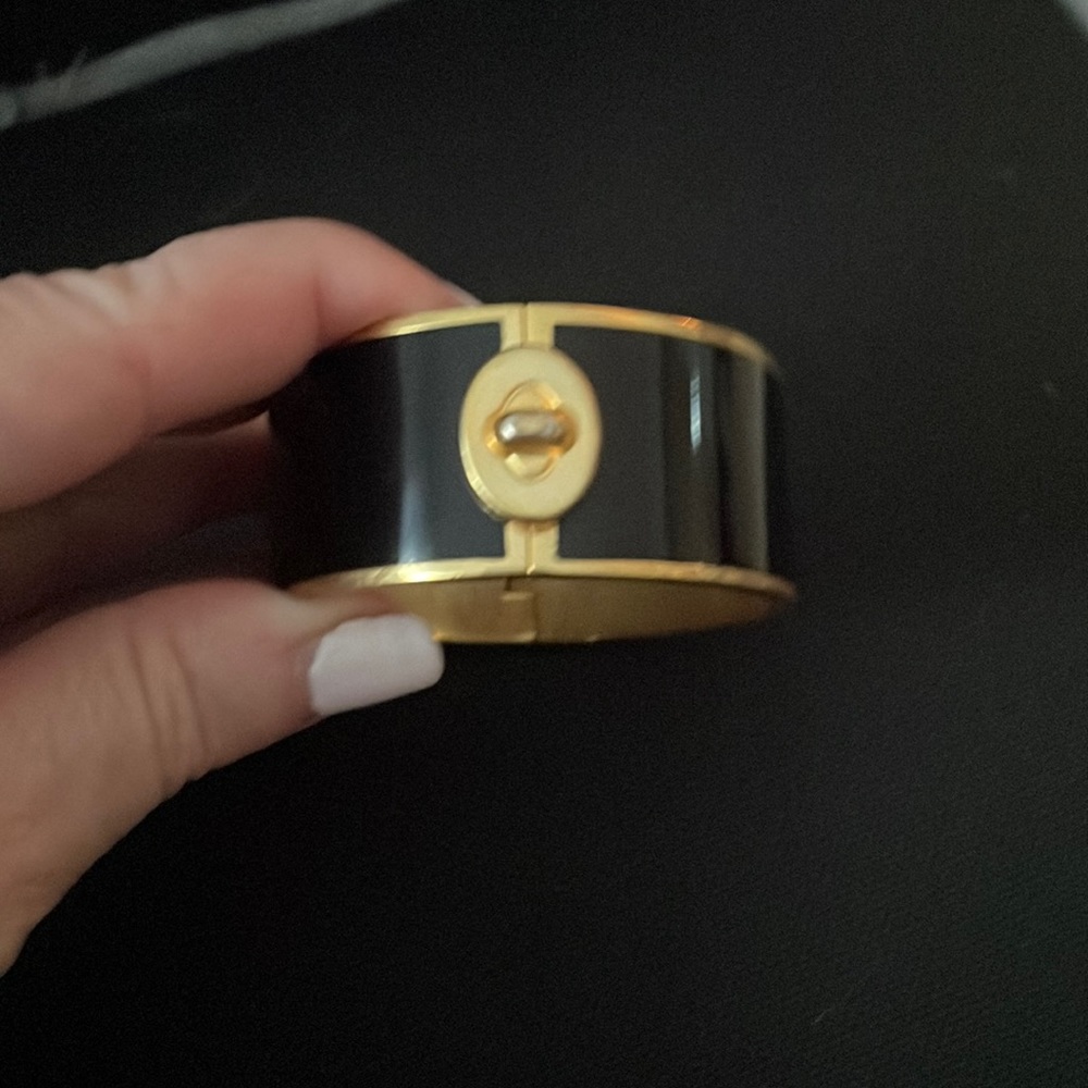 Beautiful Coach Wide Black and Gold Bangle with Turnlock Design.